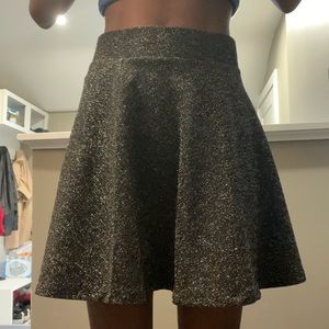 Girls black glittery wavy skirt.